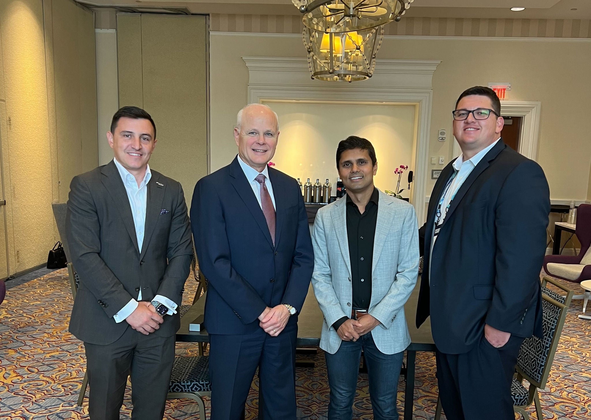 Leadership poses for a photo at the Leidos symposium