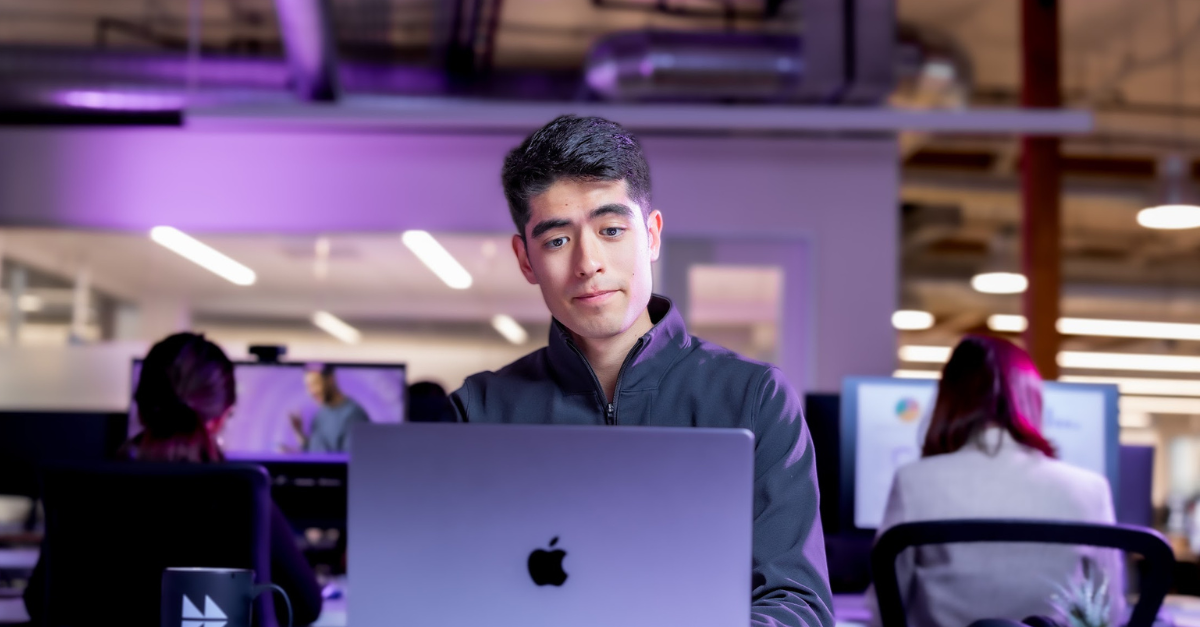 Man using AI on laptop in a modern office